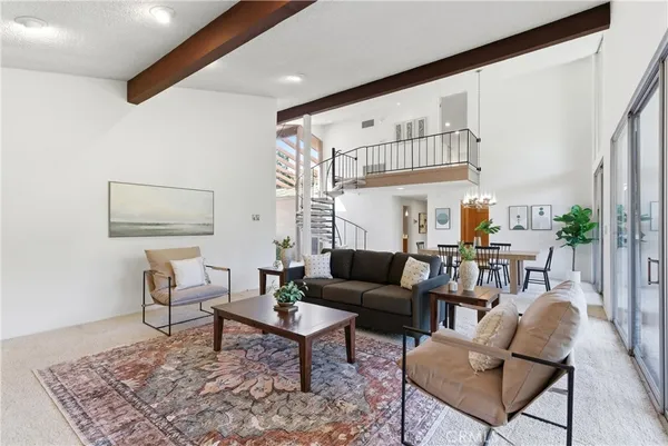 a view of a livingroom with furniture and floor to ceiling window