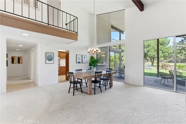 a kitchen with stainless steel appliances granite countertop a refrigerator a sink dishwasher a stove and white countertops with wooden floor