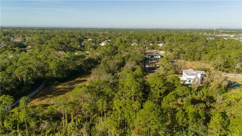 an aerial view of residential house with green space