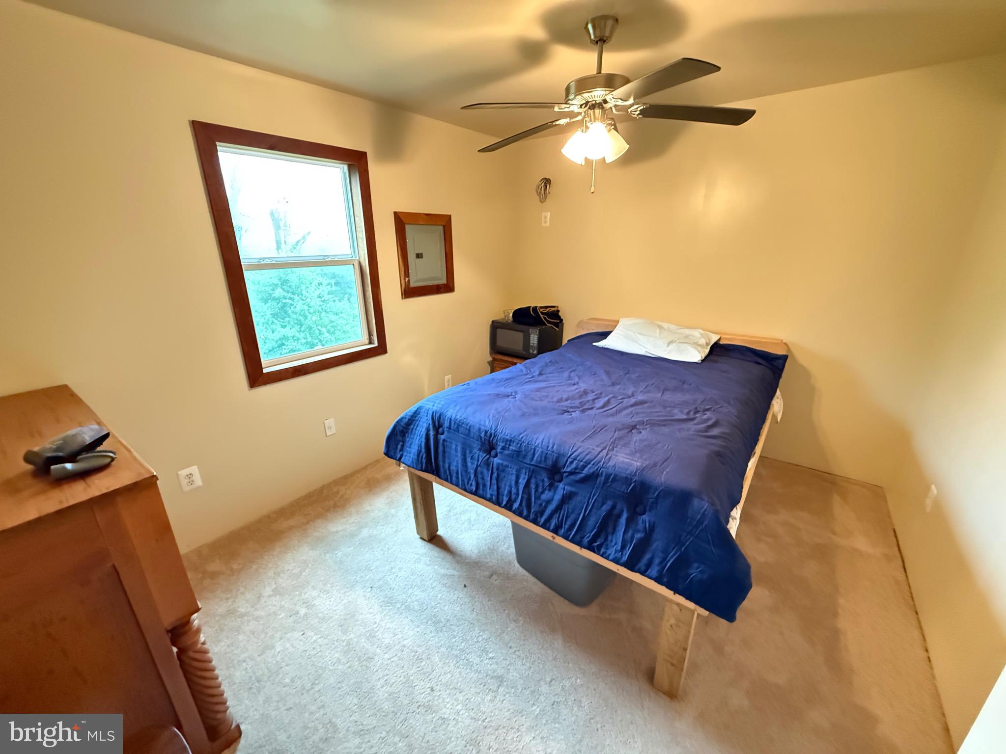 106 North Rock Ridge Lane Mount Storm, WV 26739 - Photo 8 of 78 a bedroom with a bed and a chandelier