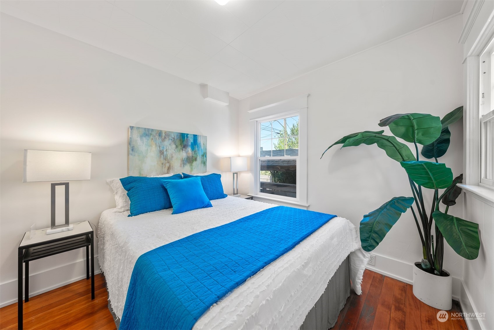 2506 Walnut Avenue Southwest Seattle, WA 98116 - Photo 11 of 29 a bedroom with a bed potted plant with the outer view