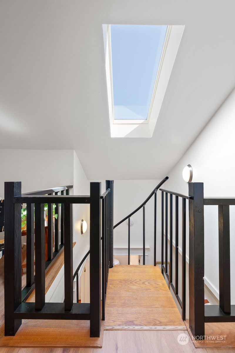 2506 Walnut Avenue Southwest Seattle, WA 98116 - Photo 16 of 29 a view of staircase with lots of frames on wall and a large window