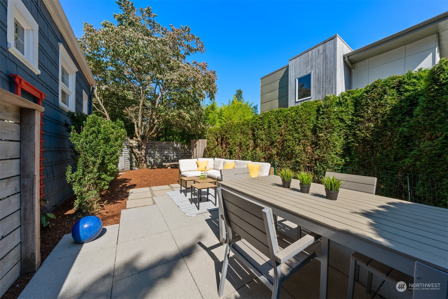 2506 Walnut Avenue Southwest Seattle, WA 98116 - Photo 26 of 29 a view of a patio with table and chairs and potted plants