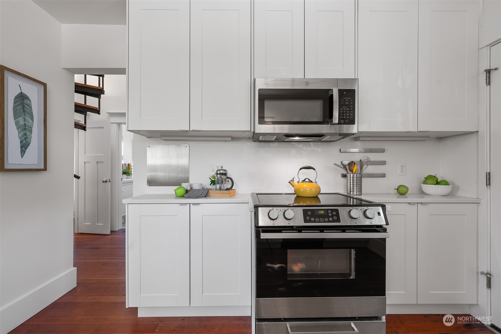 2506 Walnut Avenue Southwest Seattle, WA 98116 - Photo 8 of 29 a kitchen with stainless steel appliances a stove a microwave and cabinets