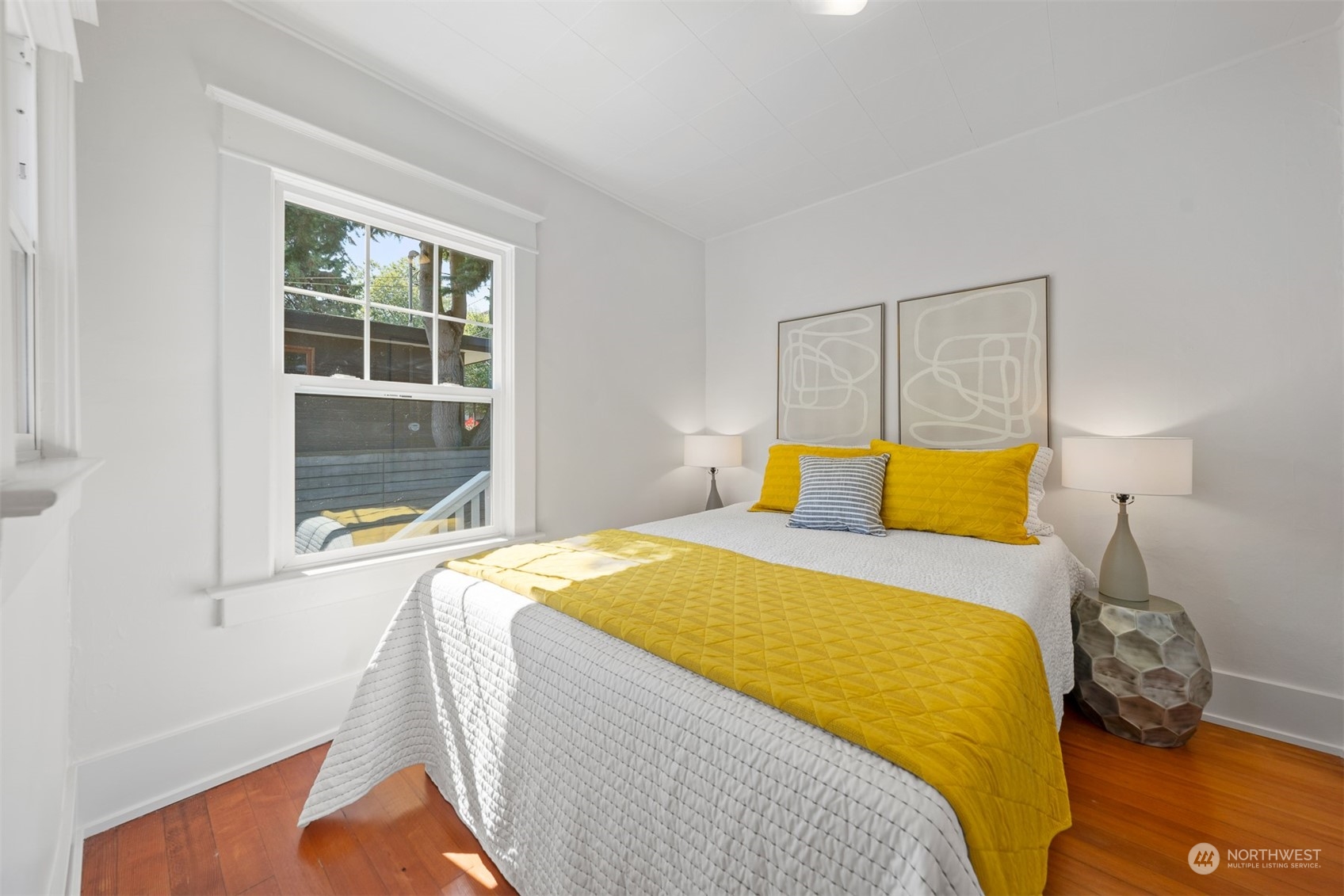 2506 Walnut Avenue Southwest Seattle, WA 98116 - Photo 9 of 29 a bedroom with a bed and wooden floor