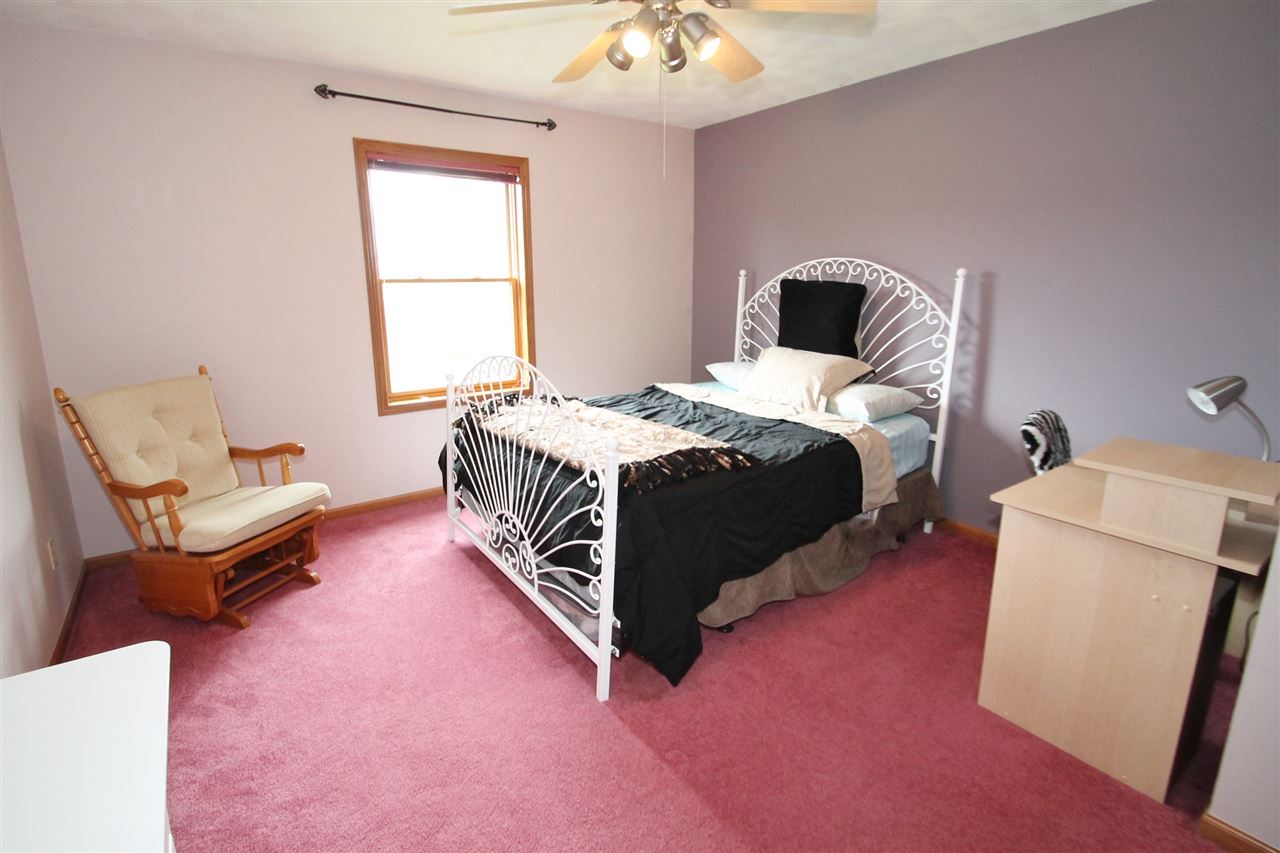 4461 Ridgeview Lane Byron, IL 61010 - Photo 19 of 25 a bedroom with a bed and a couch