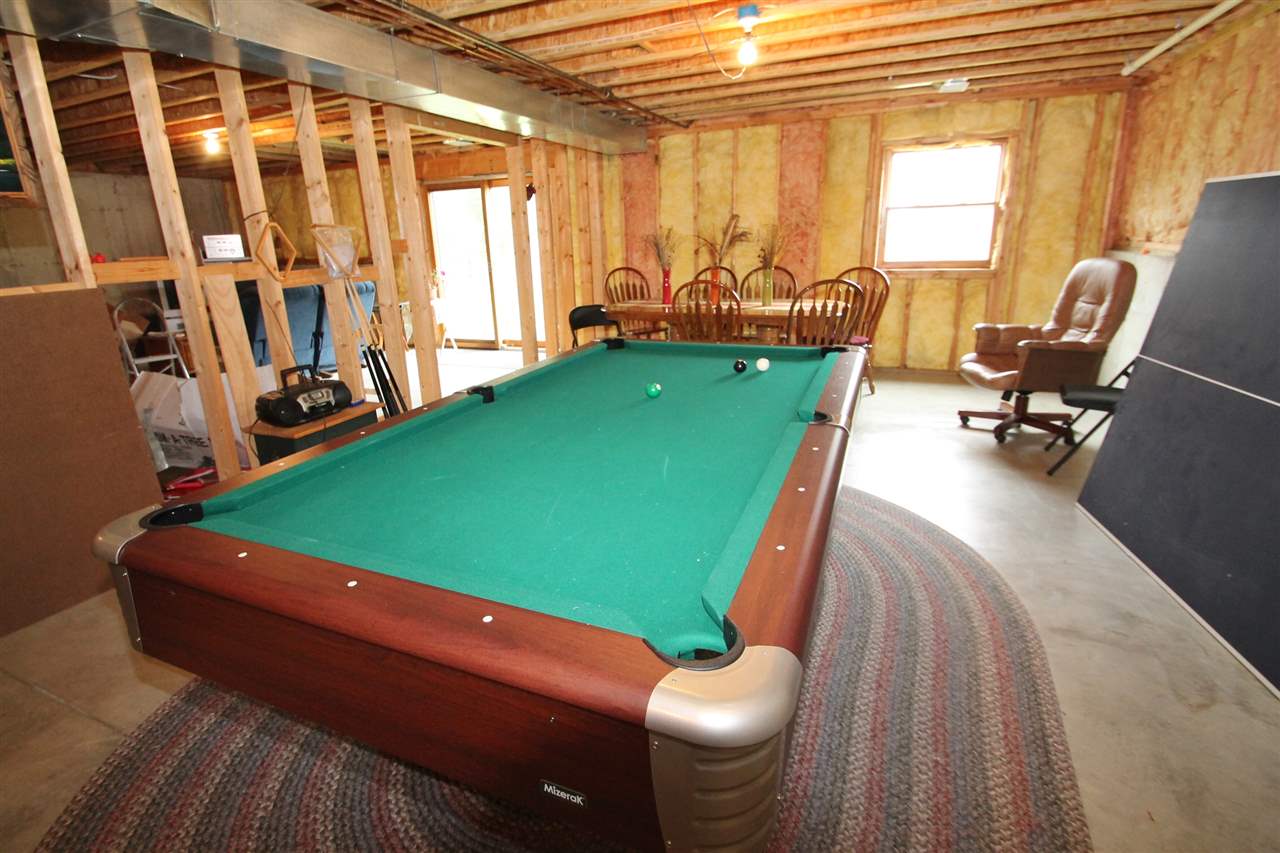 4461 Ridgeview Lane Byron, IL 61010 - Photo 20 of 25 a room with furniture and a flat screen tv