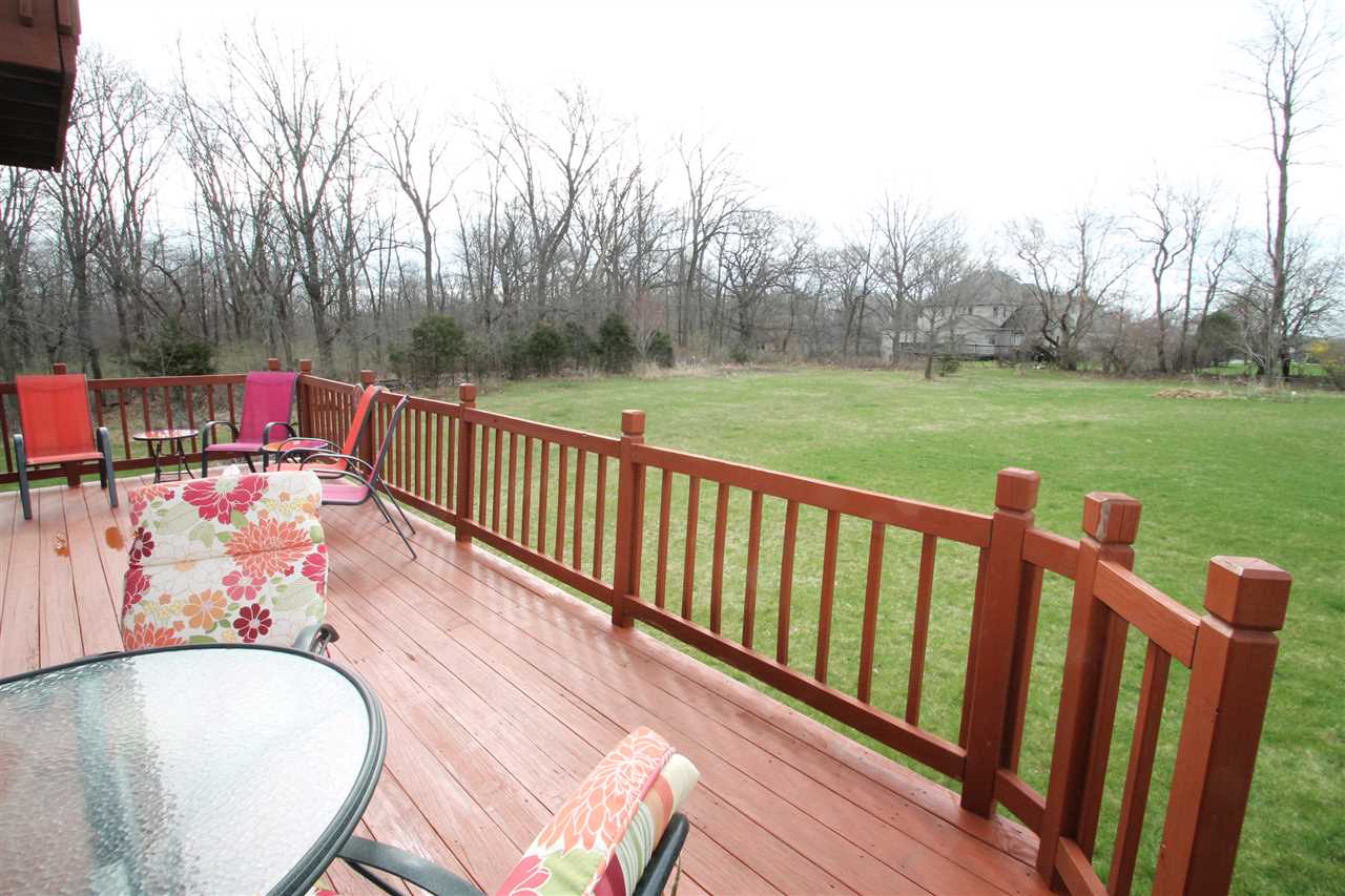 4461 Ridgeview Lane Byron, IL 61010 - Photo 21 of 25 a balcony with wooden floor table and chairs