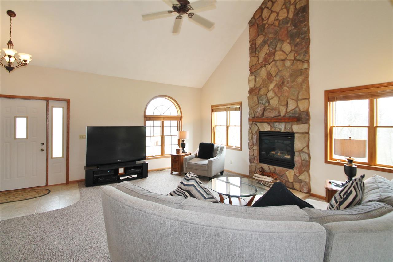 4461 Ridgeview Lane Byron, IL 61010 - Photo 3 of 25 a living room with furniture a window and a flat screen tv