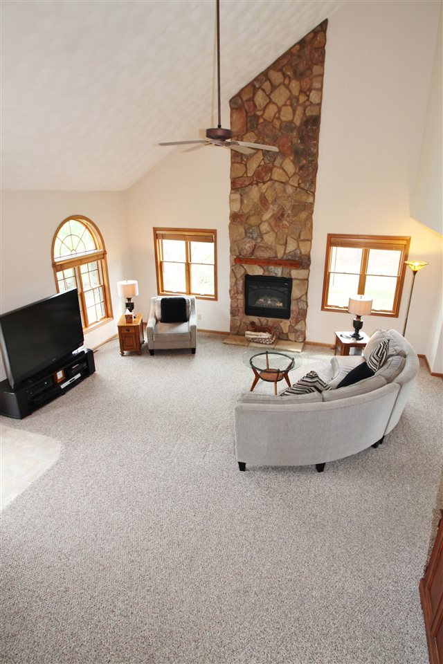 4461 Ridgeview Lane Byron, IL 61010 - Photo 4 of 25 a living room with furniture and a fireplace