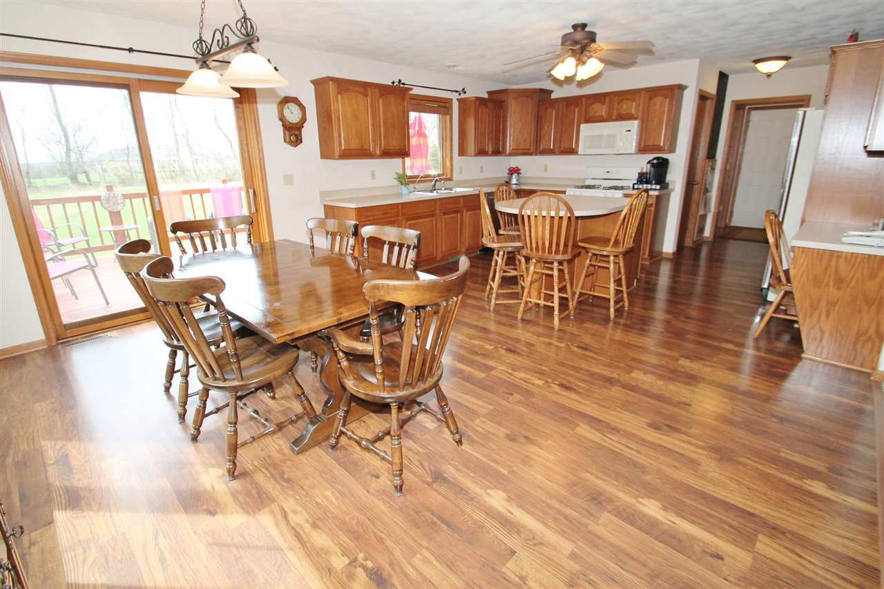 4461 Ridgeview Lane Byron, IL 61010 - Photo 6 of 25 a dining room with furniture a chandelier and wooden floor