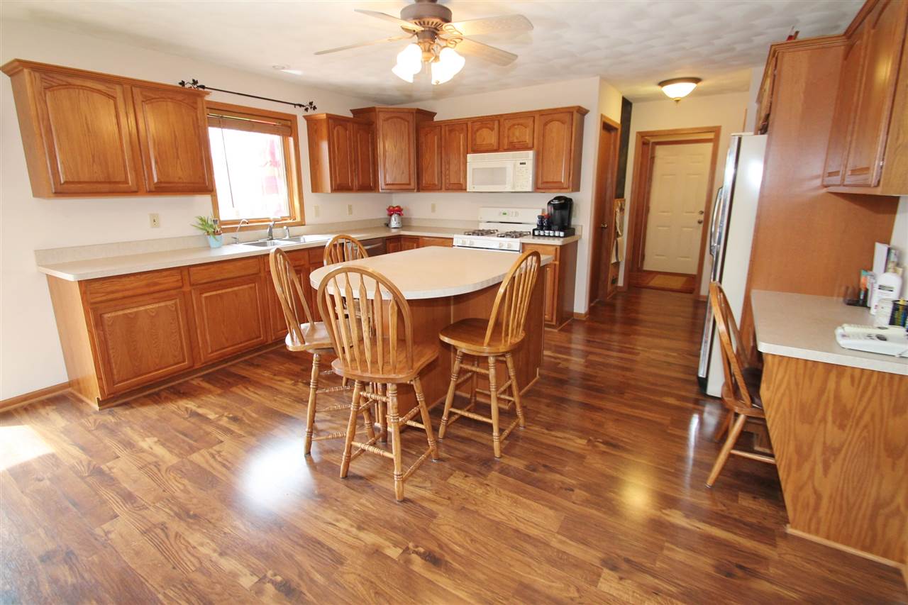 4461 Ridgeview Lane Byron, IL 61010 - Photo 8 of 25 a view of a dining room with furniture window and wooden floor