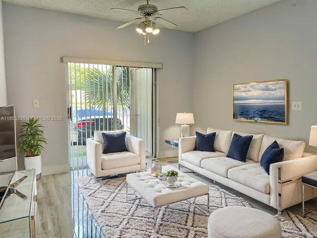 a living room with furniture and a large window