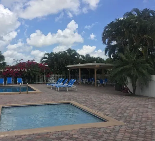 a view of a house with backyard porch and sitting area