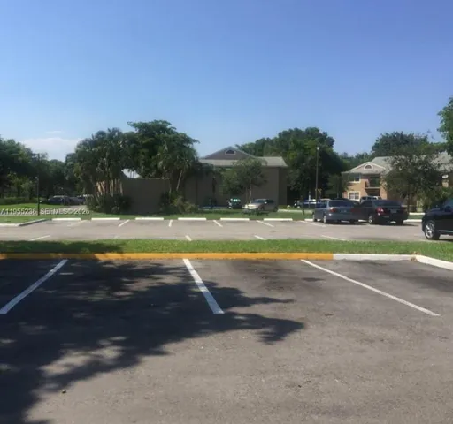 a view of a swimming pool and trees in the background