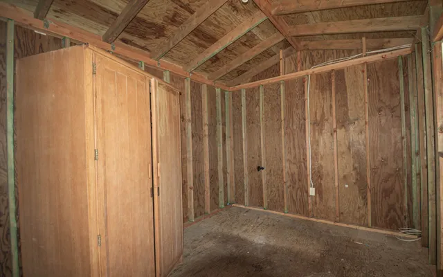 a view of a room with wooden walls