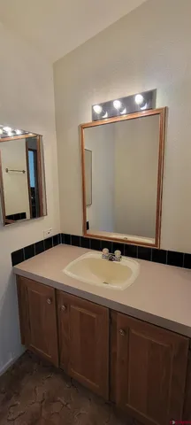a room with a sink and chandelier