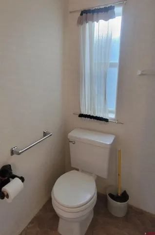 a white toilet sitting next to a shower curtain