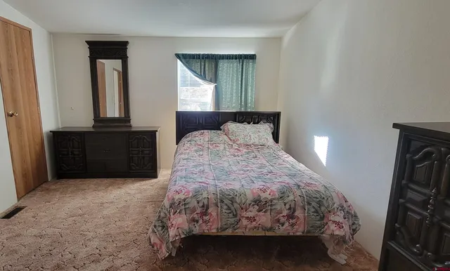 a bedroom with a bed and a mirror