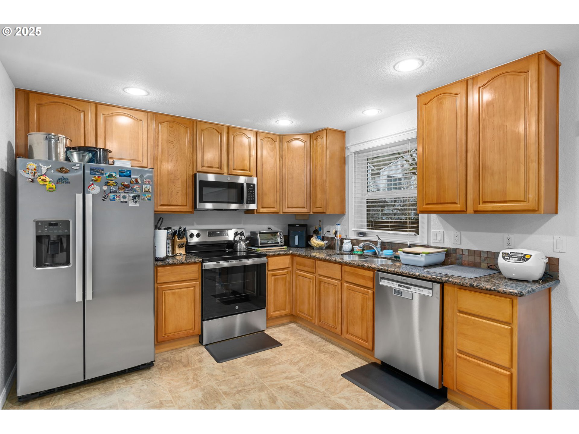 11938 Southeast Market Street Portland, OR 97216 - Photo 11 of 28 a kitchen with stainless steel appliances granite countertop a stove a sink dishwasher a refrigerator and a microwave