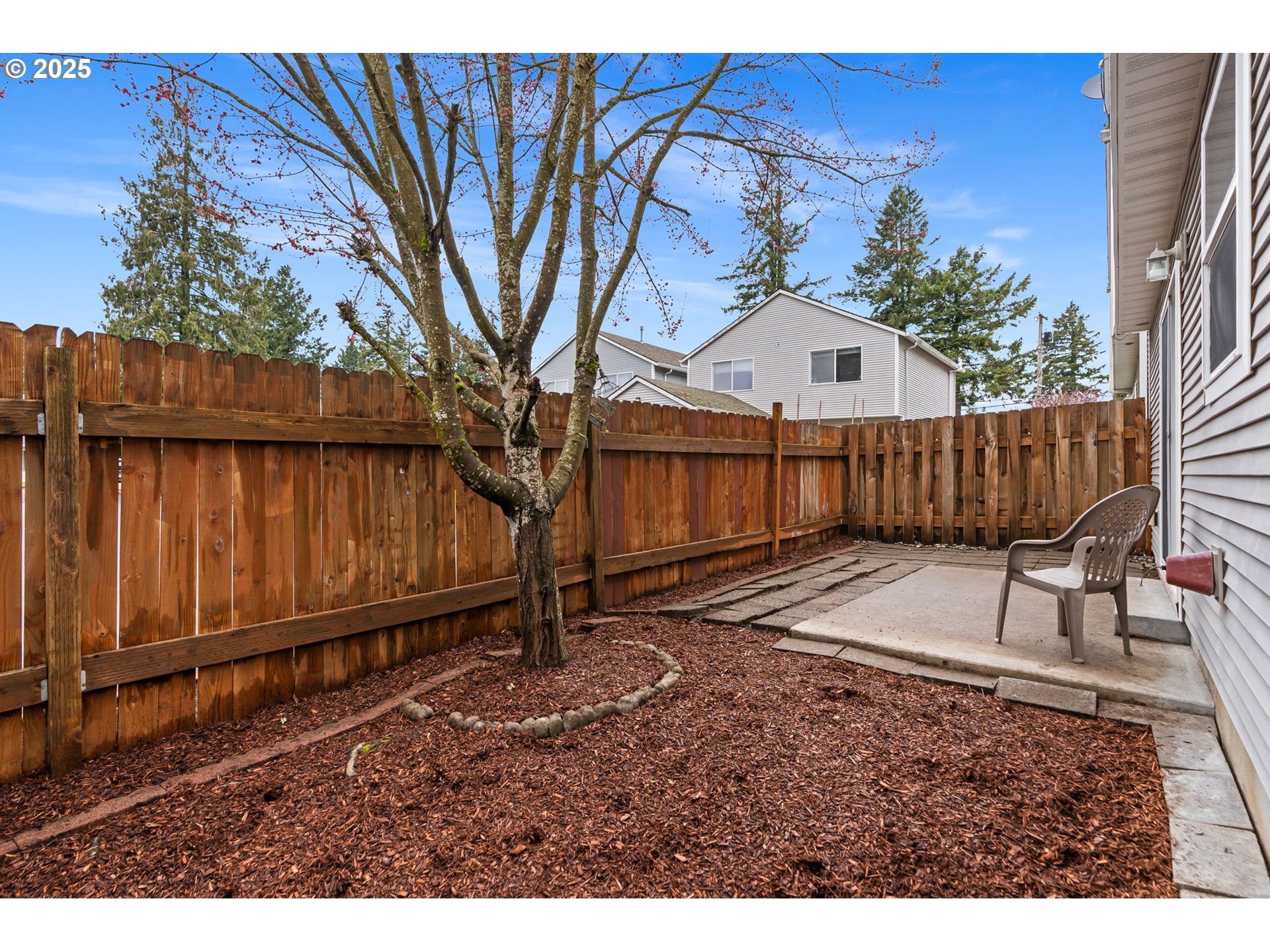11938 Southeast Market Street Portland, OR 97216 - Photo 27 of 28 a view of a backyard with a small deck and wooden fence