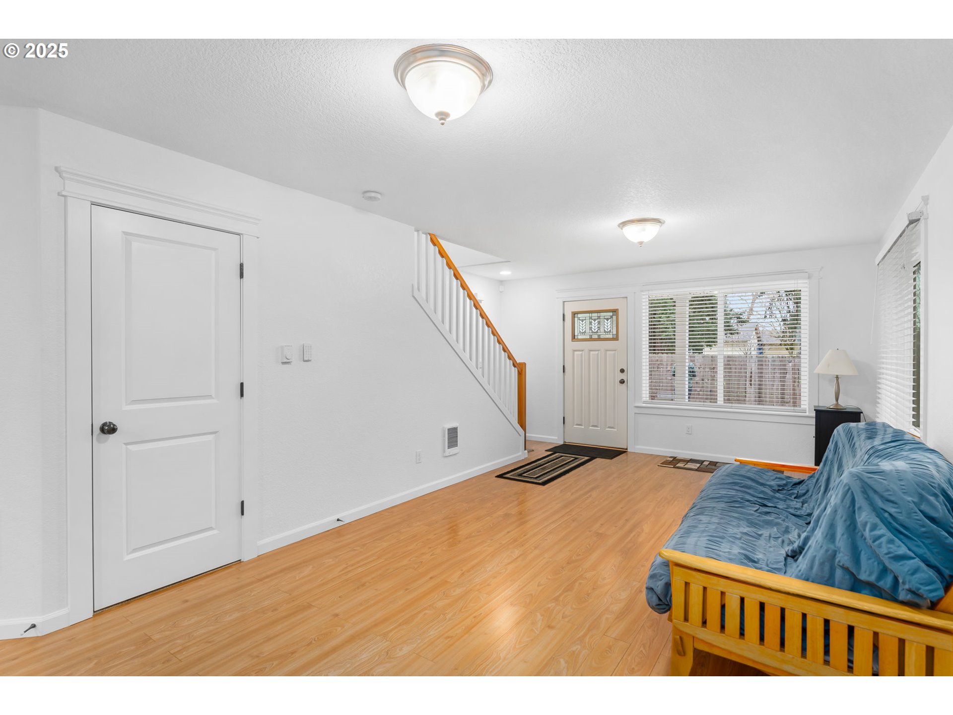 11938 Southeast Market Street Portland, OR 97216 - Photo 5 of 28 a bedroom with a large bed and wooden floor