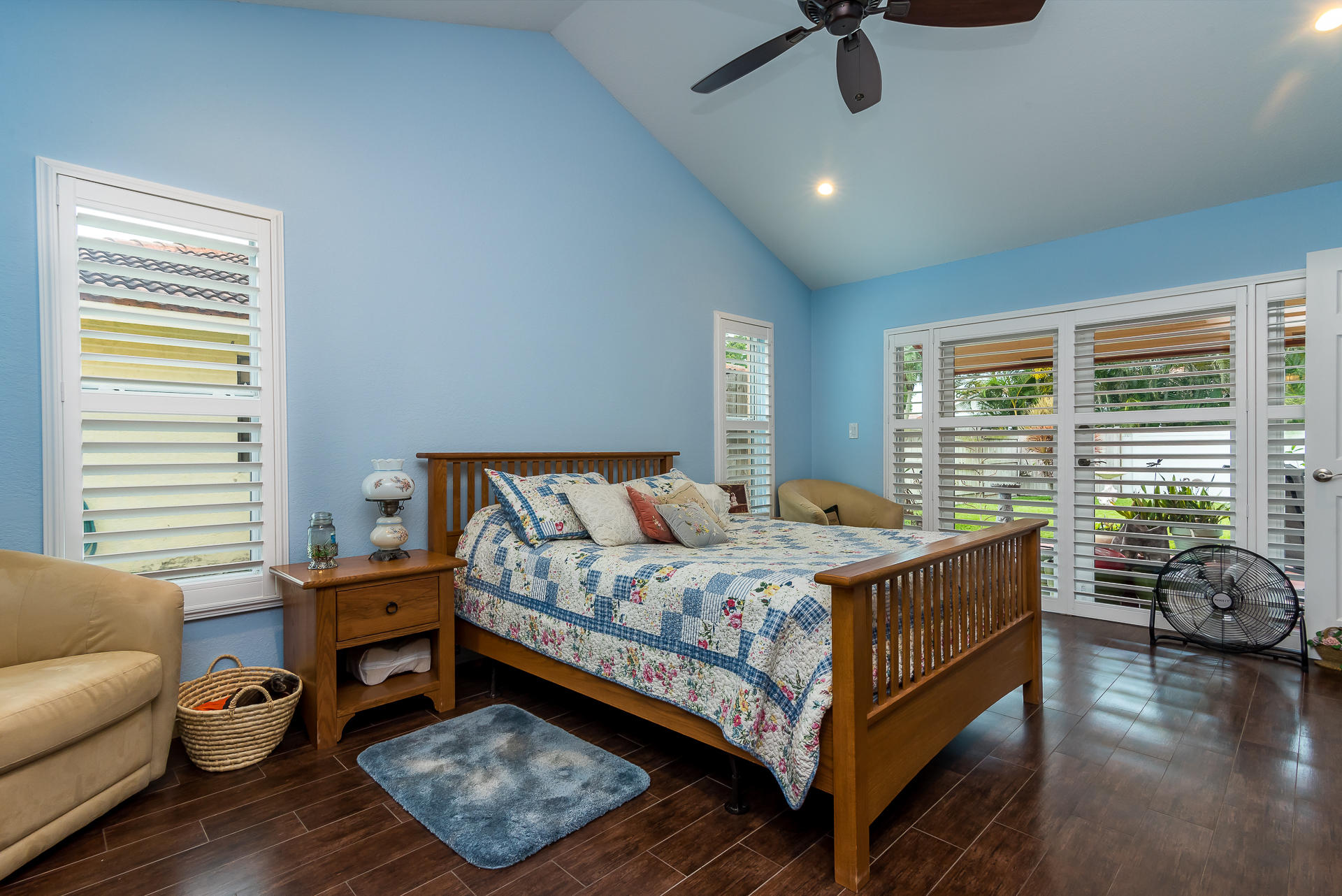 23369 Lago Mar Circle Boca Raton, FL 33433 - Photo 21 of 25 a bedroom with a bed a couch and a chandelier