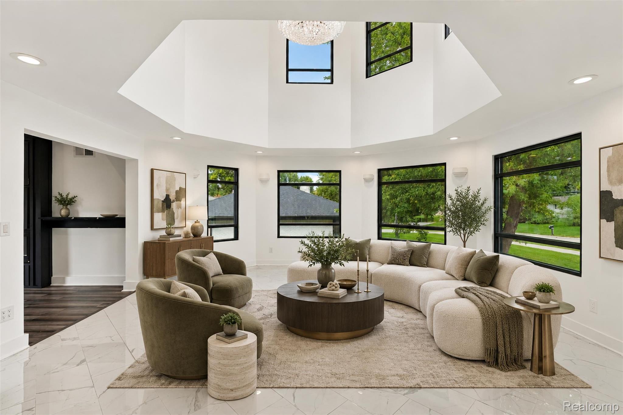 27507 Bell Road Southfield, MI 48034 - Photo 11 of 81 Double-height living area featuring a large chandelier, multiple windows with dark frames, recessed lighting, and white tile flooring