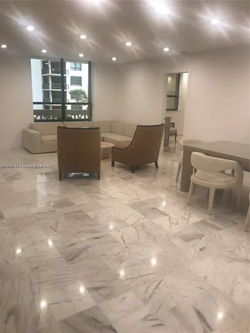 a lobby with furniture and a potted plant