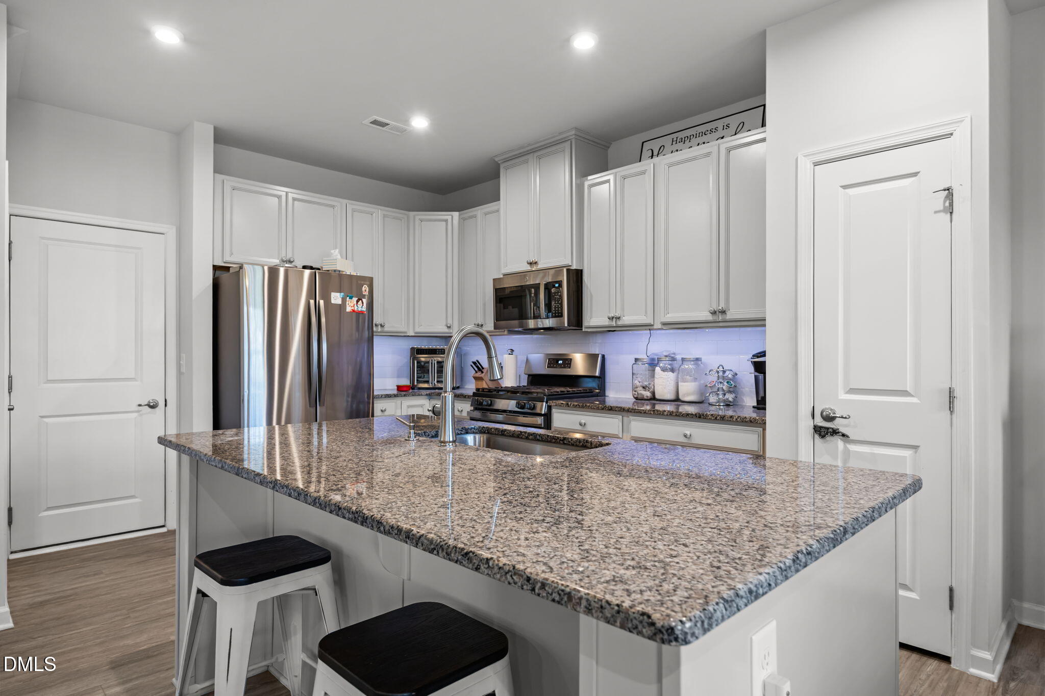 1624 Ripley Woods Street Wake Forest, NC 27587 - Photo 14 of 41 a kitchen with stainless steel appliances granite countertop a sink refrigerator and microwave