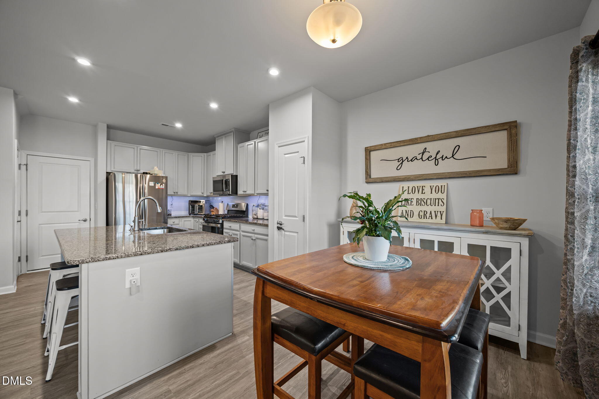1624 Ripley Woods Street Wake Forest, NC 27587 - Photo 20 of 41 a kitchen with a table and chairs