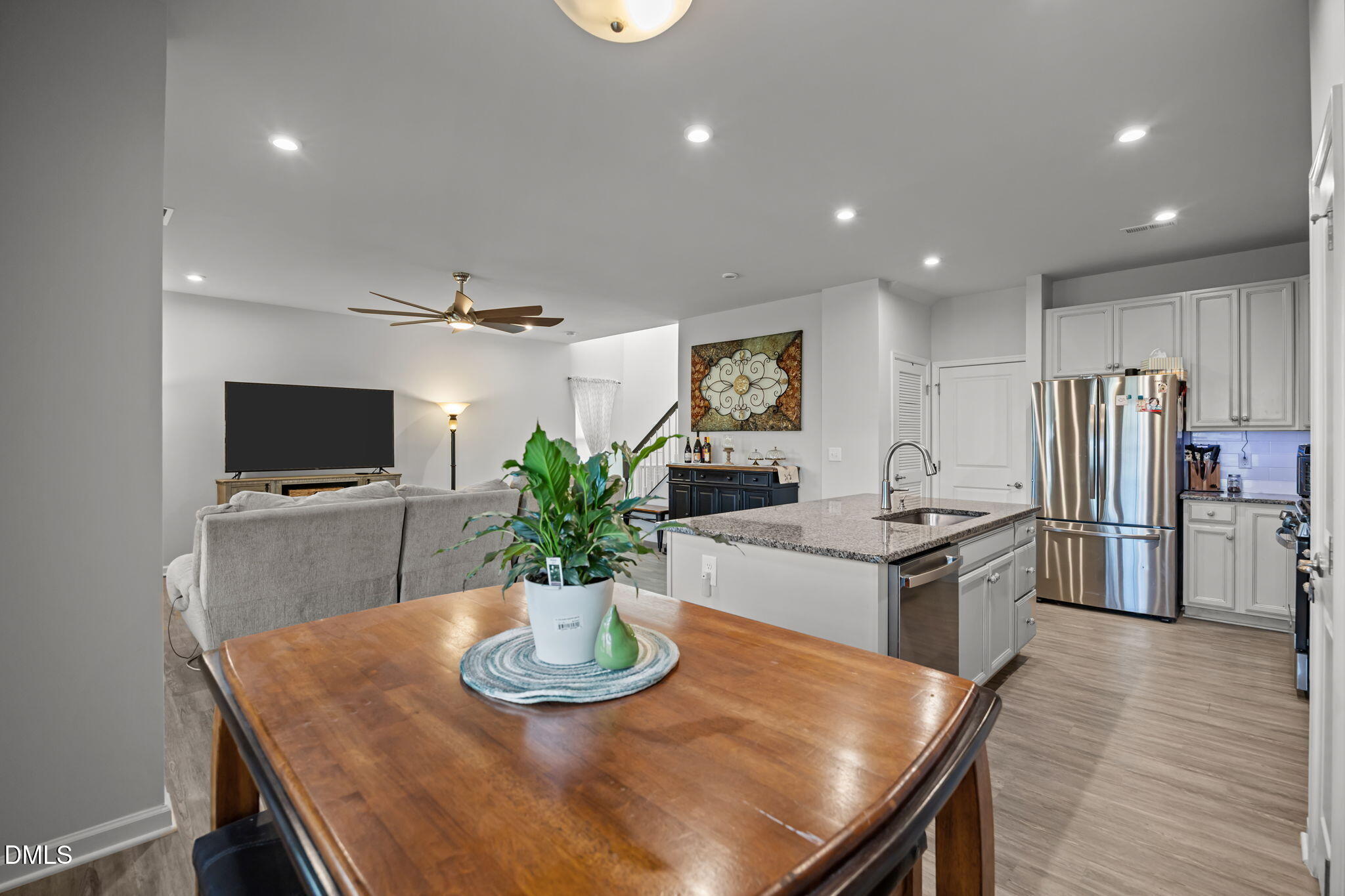 1624 Ripley Woods Street Wake Forest, NC 27587 - Photo 21 of 41 a kitchen with stainless steel appliances granite countertop a sink a stove a dining table and chairs