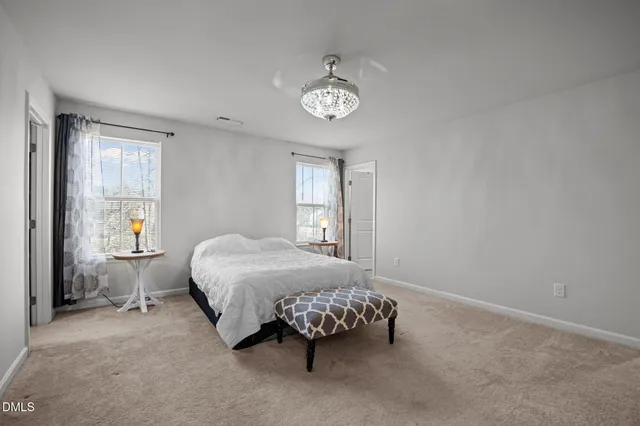 a bed sitting in a bedroom next to a window