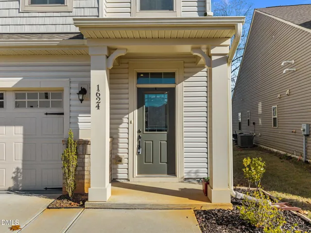 a front view of a house with a garage