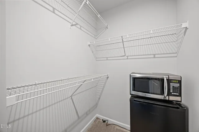 a view of storage and utility room with racks on the wall