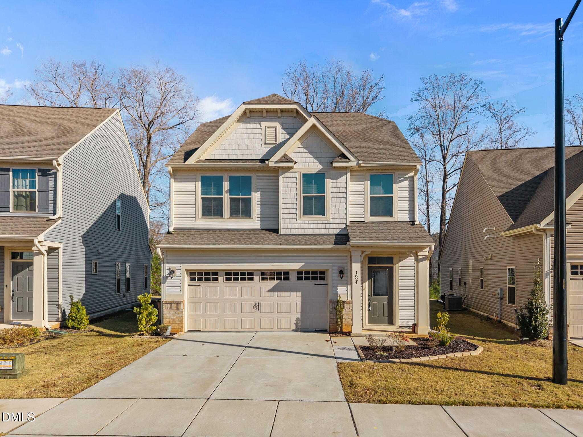 1624 Ripley Woods Street Wake Forest, NC 27587 - Photo 3 of 41 a front view of a house with garden