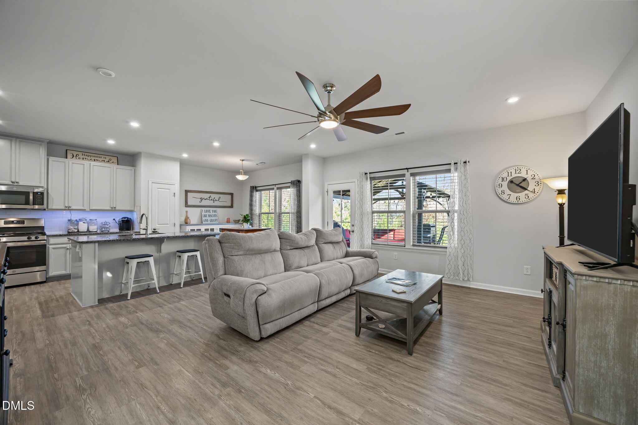 1624 Ripley Woods Street Wake Forest, NC 27587 - Photo 8 of 41 a living room with furniture and a flat screen tv with kitchen view