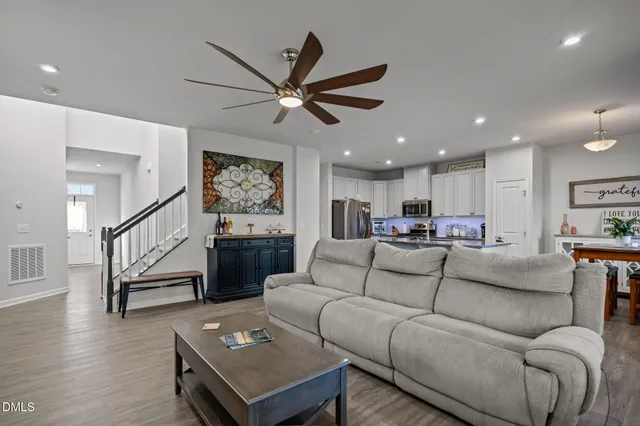 a living room with furniture and wooden floor