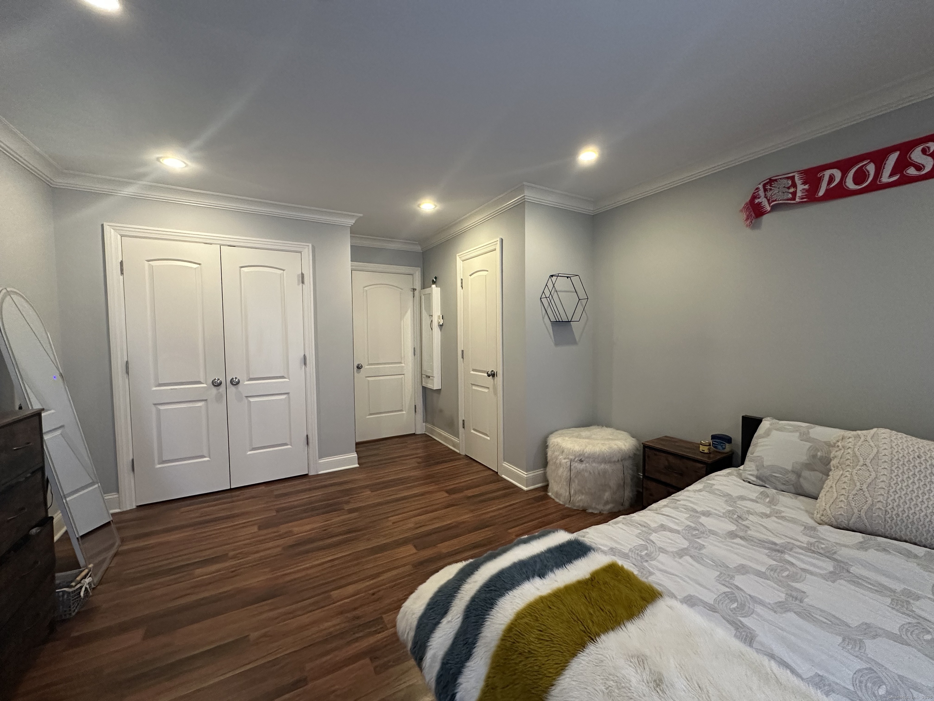 697 Cove Road, Unit 1E Stamford, CT 06902 - Photo 11 of 14 a bedroom with two beds and a flat screen tv