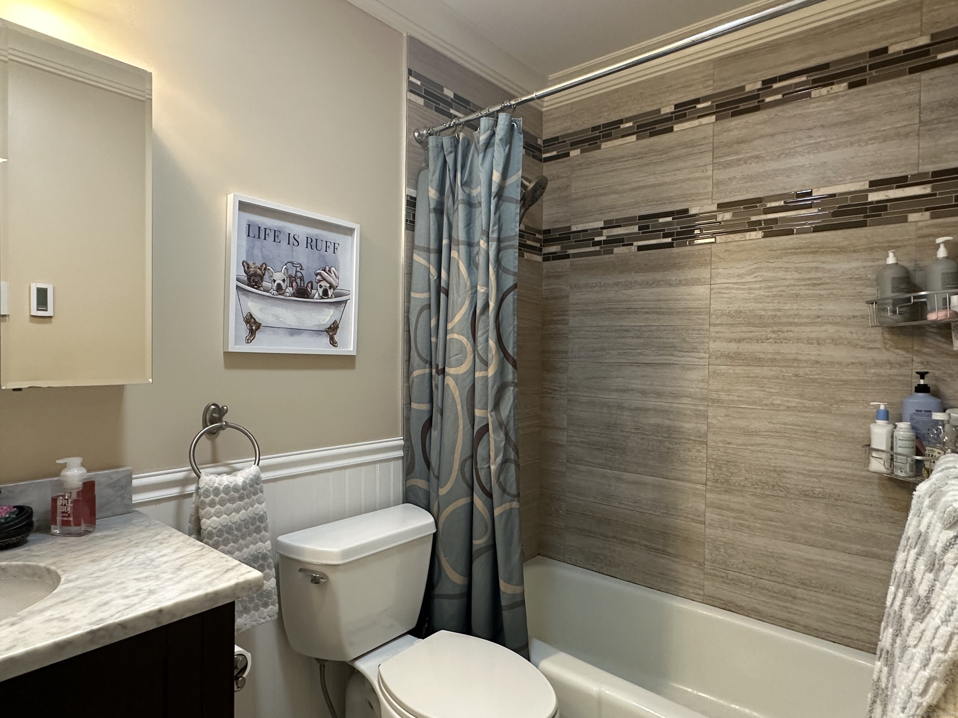 697 Cove Road, Unit 1E Stamford, CT 06902 - Photo 13 of 14 a white toilet sitting next to a bath tub