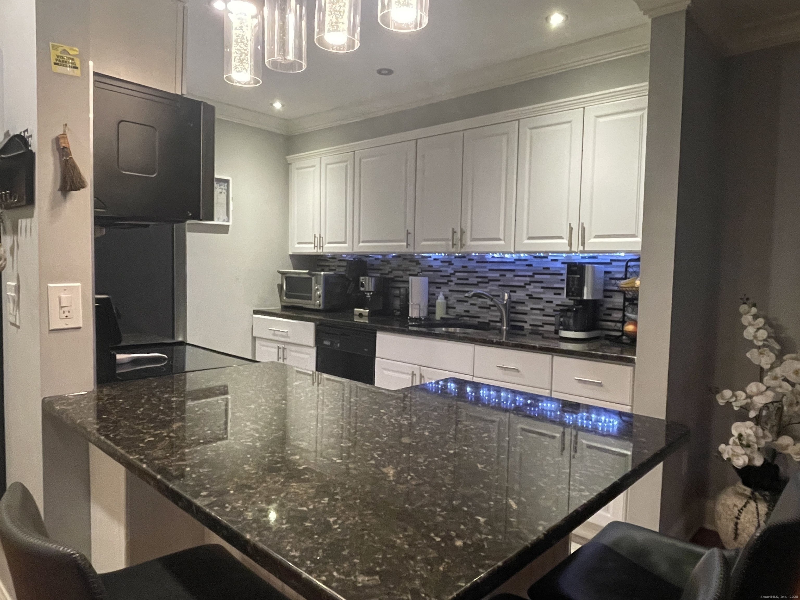 697 Cove Road, Unit 1E Stamford, CT 06902 - Photo 4 of 14 a kitchen with stainless steel appliances granite countertop a sink a stove and a refrigerator