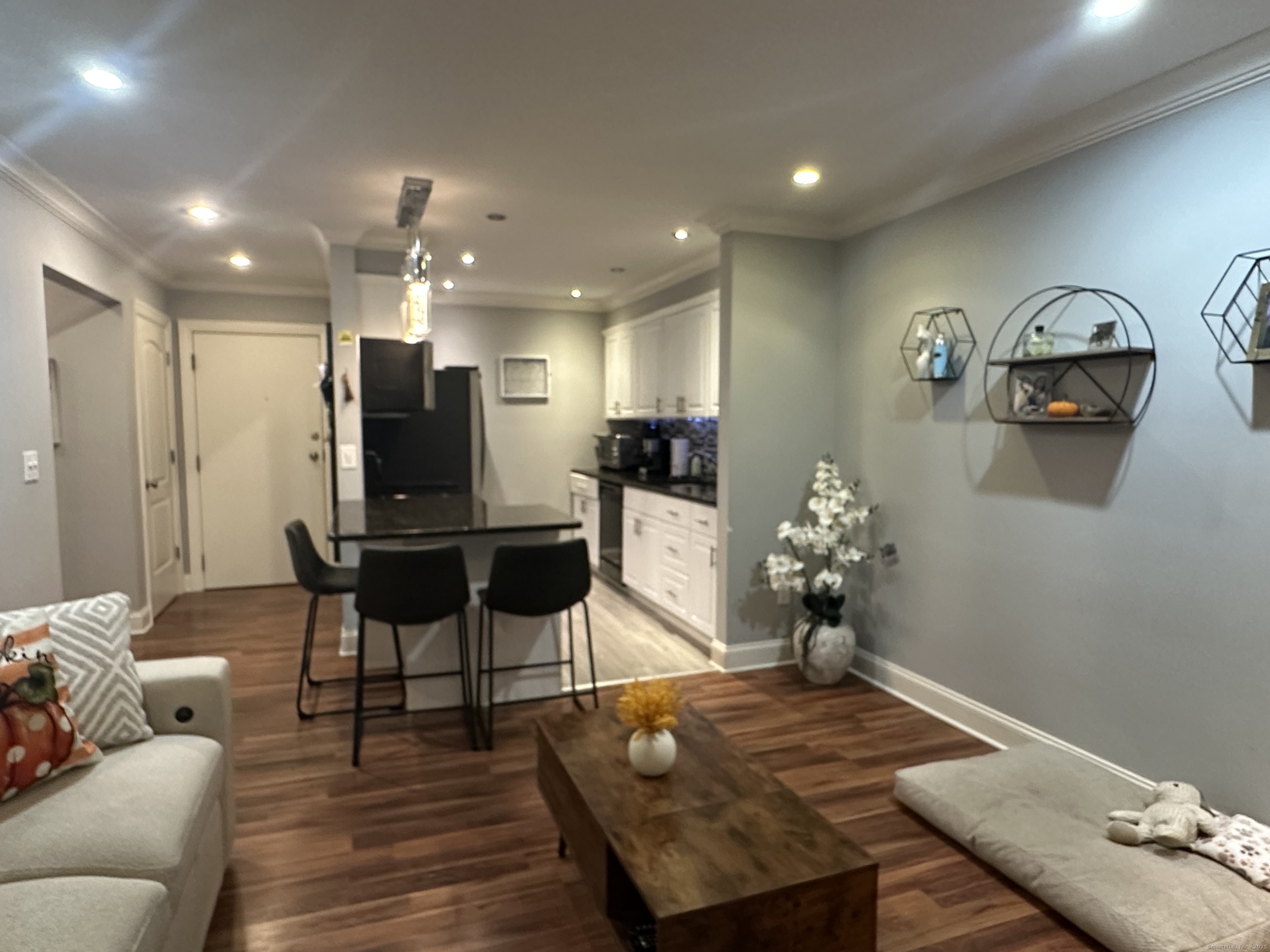 697 Cove Road, Unit 1E Stamford, CT 06902 - Photo 5 of 14 a living room with furniture and wooden floor