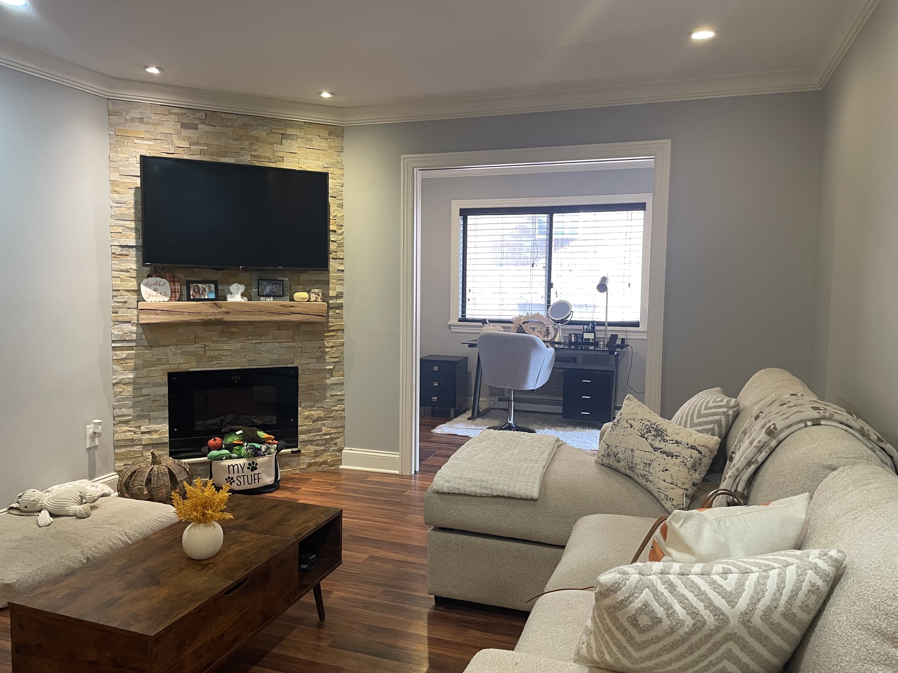 697 Cove Road, Unit 1E Stamford, CT 06902 - Photo 6 of 14 a living room with furniture fireplace and flat screen tv