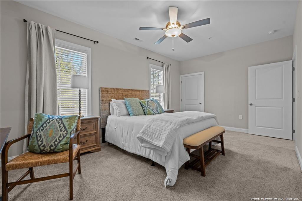 200 Gallery Drive, Unit 301 Spring Lake, NC 28390 - Photo 13 of 21 a bedroom with a bed a chair and a chandelier