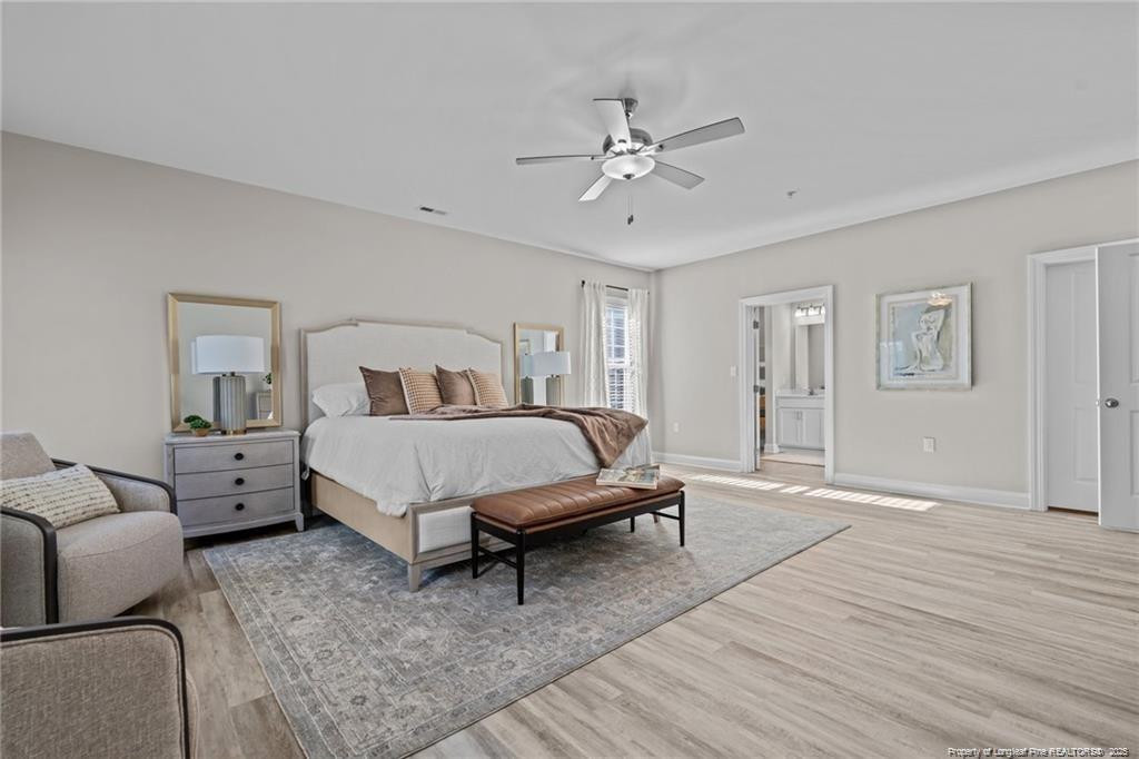 200 Gallery Drive, Unit 301 Spring Lake, NC 28390 - Photo 17 of 21 a bed room with a bed and a chandelier