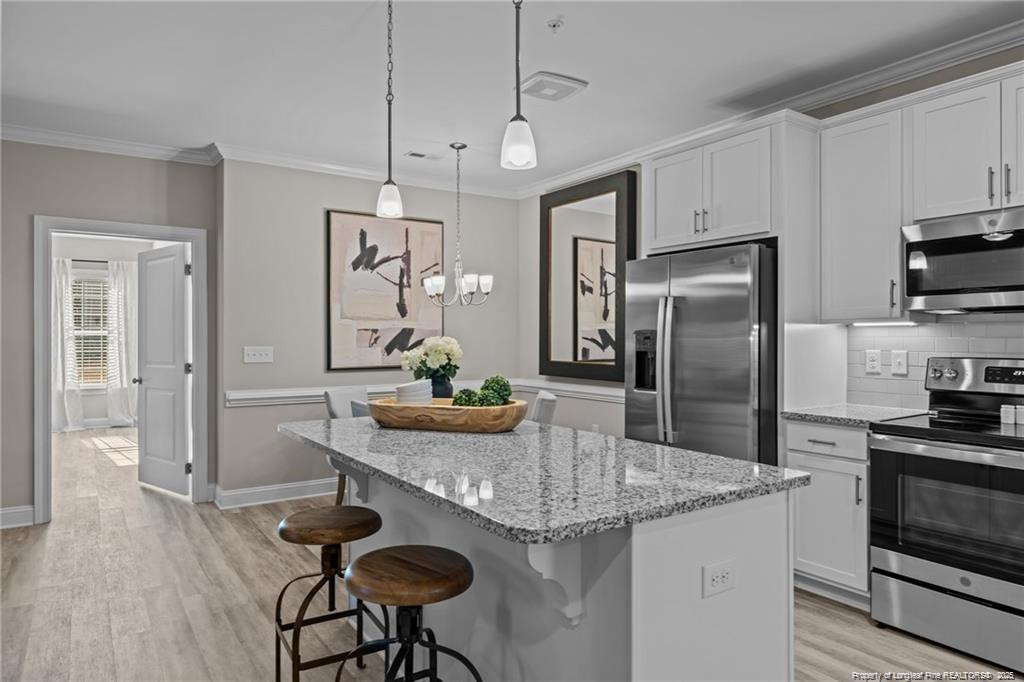 200 Gallery Drive, Unit 301 Spring Lake, NC 28390 - Photo 5 of 21 a kitchen with stainless steel appliances granite countertop a sink a stove a refrigerator cabinets and dining table