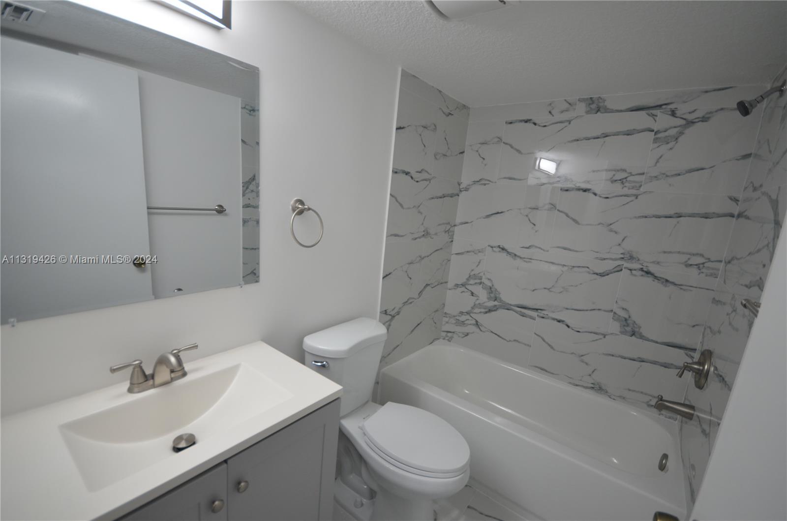 1241 Southeast 29th Street, Unit 102 Homestead, FL 33035 - Photo 19 of 23 a bathroom with a sink toilet and shower