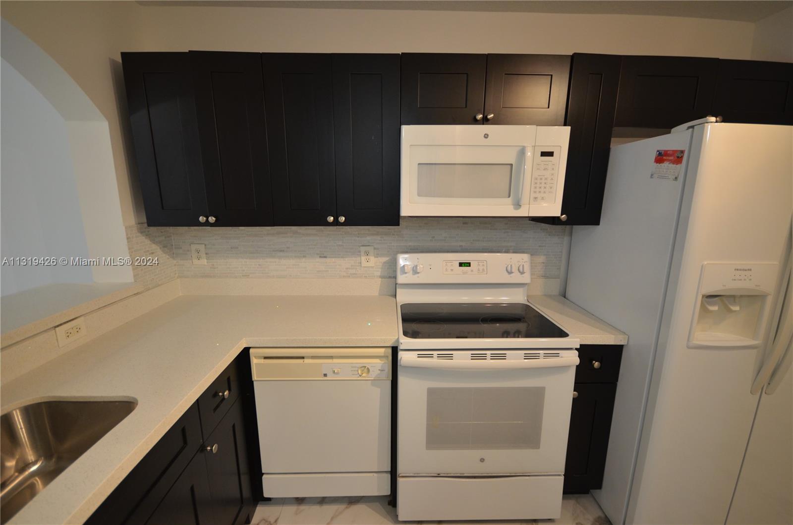 1241 Southeast 29th Street, Unit 102 Homestead, FL 33035 - Photo 2 of 23 a utility room with dryer and washer