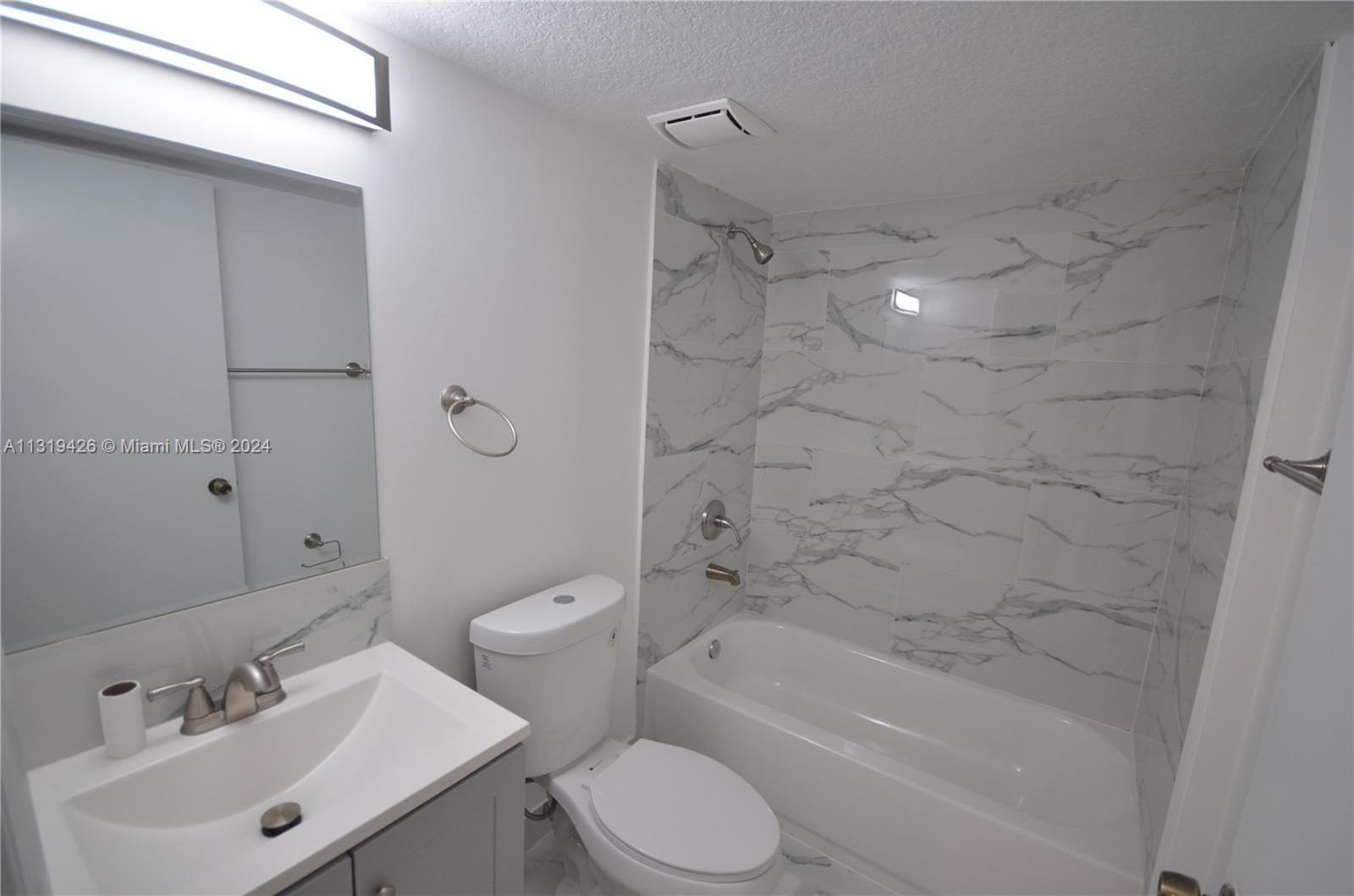 1241 Southeast 29th Street, Unit 102 Homestead, FL 33035 - Photo 9 of 23 a bathroom with a sink toilet and shower