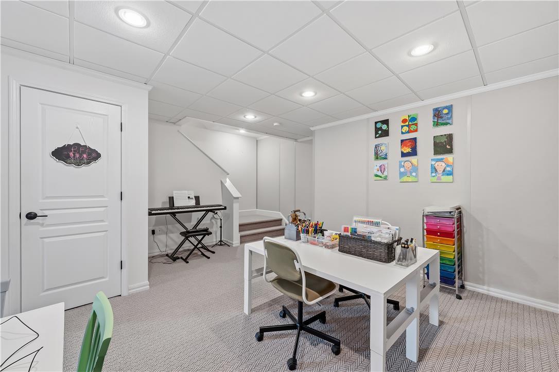 9031 Pathfinder Road Breinigsville, PA 18031 - Photo 48 of 63 A well-lit, finished basement space offers versatility for a creative play area or home office.